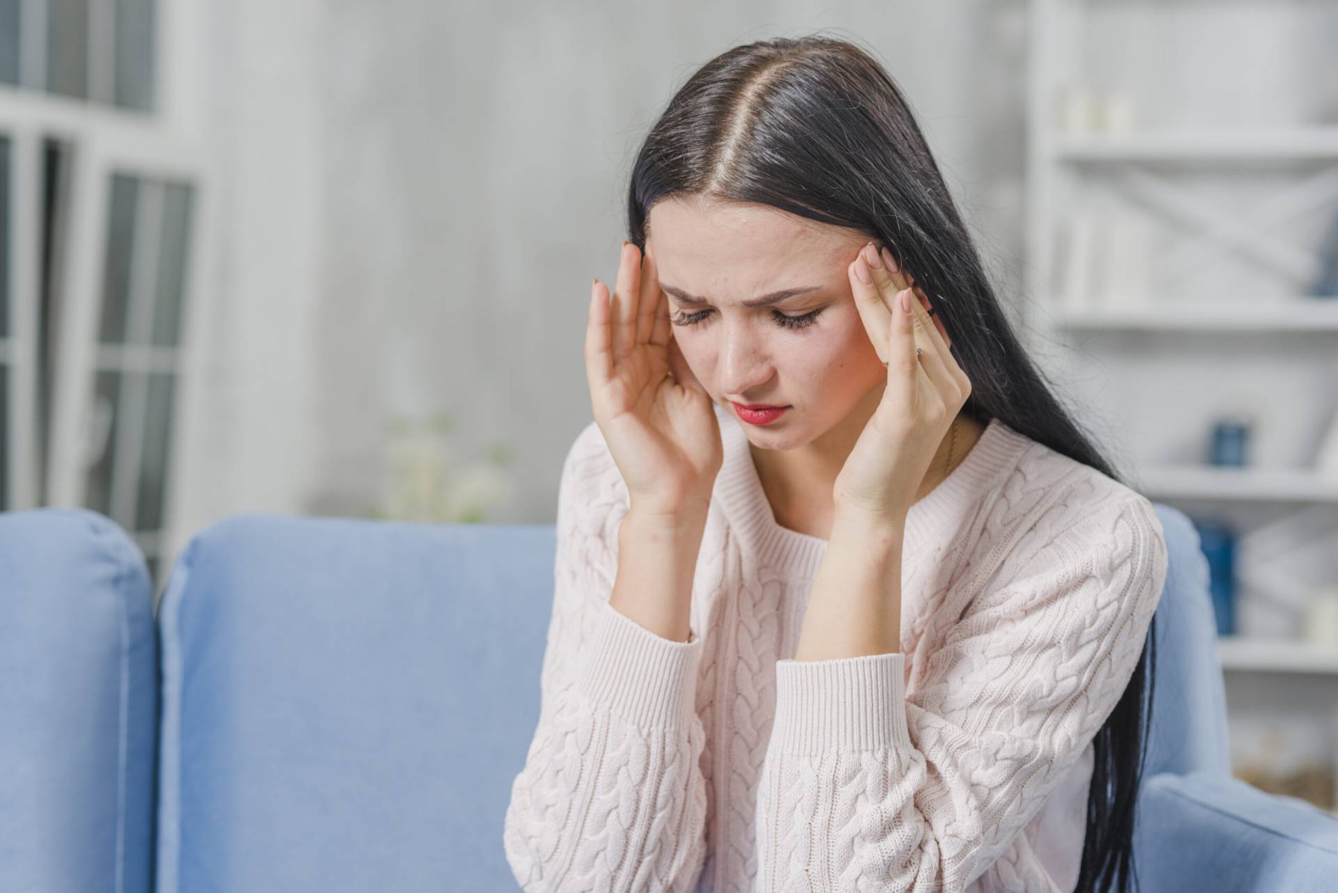 beautiful young woman having headache scaled